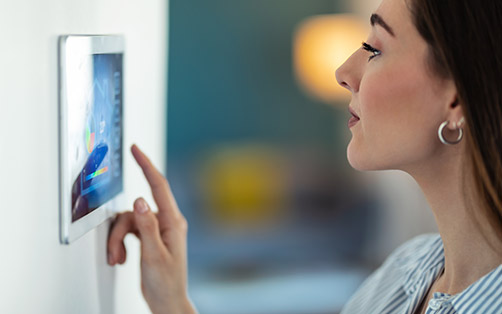 Women checking her smart security system control panel